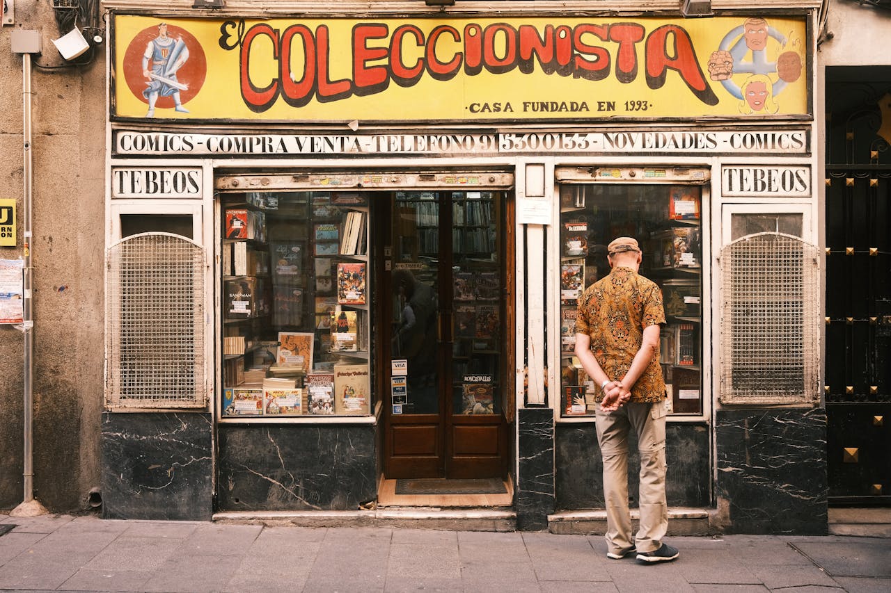 A man window shopping outside a vintage comic store in Madrid, Spain.